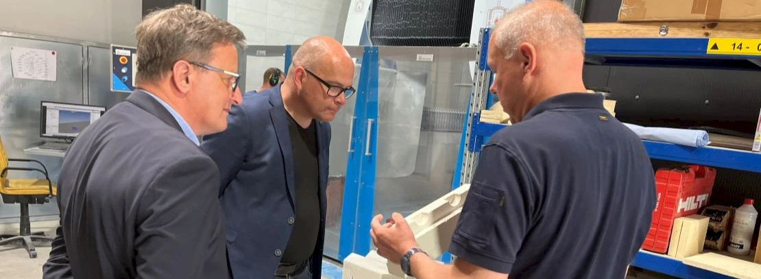 President, CEO, and Mr. Schulz examine a processed stone from the stone processing center together.